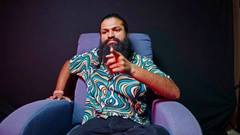 Guy sits glaring with hatred and outrage Stock Footage 296530740