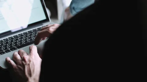 Guy sits on the windowsill and running on the laptop on his lap. Stock Footage 68409502