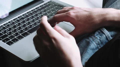 Guy sits on the windowsill and running on the laptop on his lap. 스톡 동영상 68409524