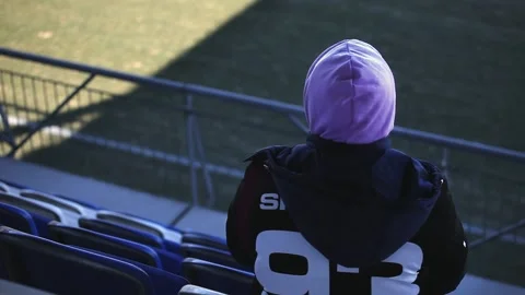 A guy is sitting alone in the stands Stock Footage 268572547