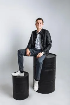 The guy sitting on the barrel. The guy in the Studio. The guy in the black ja Stock Photos