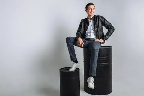 The guy sitting on the barrel. The guy in the Studio. The guy in the black ja Stock Photos