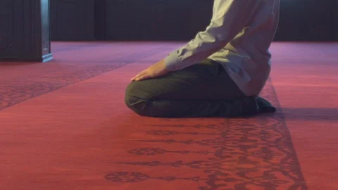 Guy sitting down in empty mosque Stock Footage 88032807