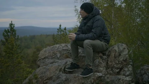Guy is sitting in the forest Stock Footage 91183669