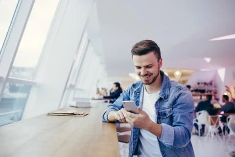 Guy is sitting in front of the table near window Foto stock
