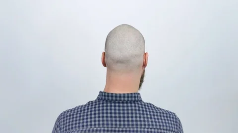 The guy sitting with his back to the camera and shows his bald head. Stock Footage 122012511