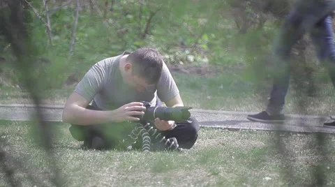 The guy sitting on the lawn with a camera and shoots people Stock Footage 49669492