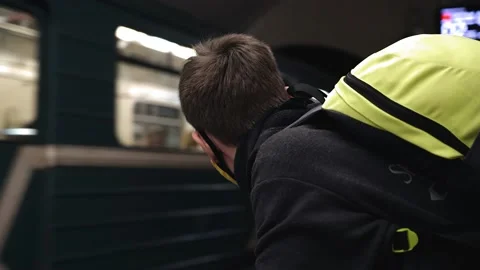 The guy is sitting at the metro station where the train arrives Stock Footage 154136131