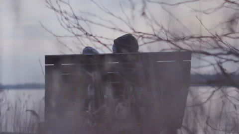 Guy sitting park bench watching scenery talking dramatic talk silhouette Vídeos de archivo 166458030