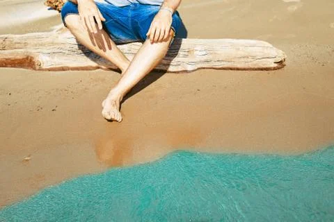 Guy sitting by the sea Stock Photos