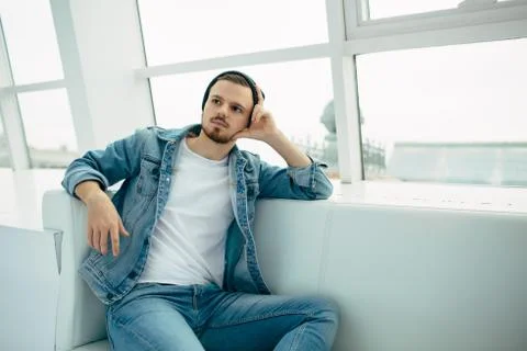 Guy is sitting on sofa and thinking Stock Photos