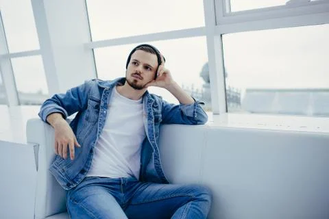 Guy is sitting on sofa and thinking Stock Photos