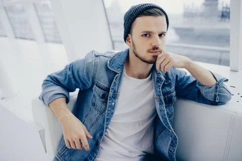 Guy is sitting on sofa and thinking Stock Photos
