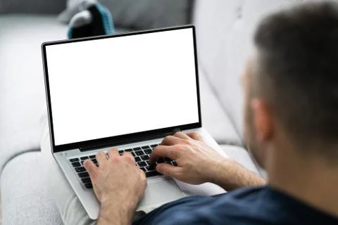 Guy Sitting On Sofa Using Laptop Stock Photos