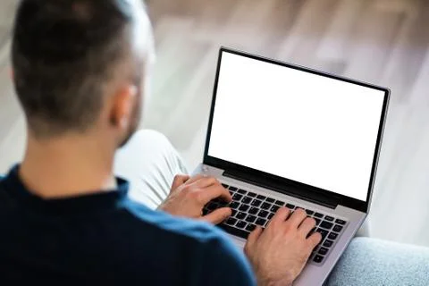 Guy Sitting On Sofa Using Laptop Stock Photos