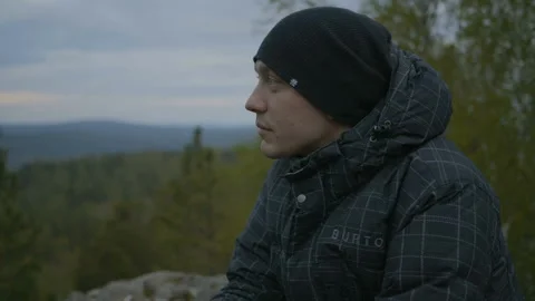 Guy is sitting on the stone Stock Footage 91183917