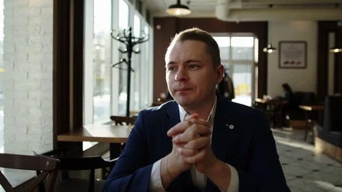 Guy is sitting at a table and that emotionally tells Stock Footage 81828310