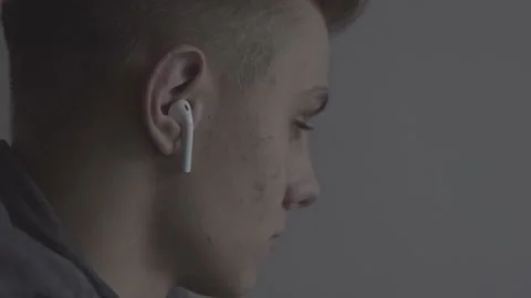 The guy is sitting at the table by the laptop. The guy writes, draws. Stock Footage 130219126