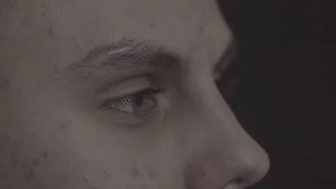 The guy is sitting at the table by the laptop. The guy writes, draws. Stock Footage 130219244