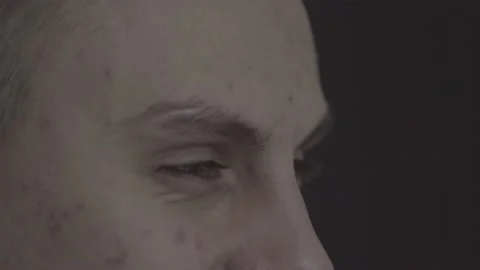 The guy is sitting at the table by the laptop. The guy writes, draws. Stock Footage 130219293