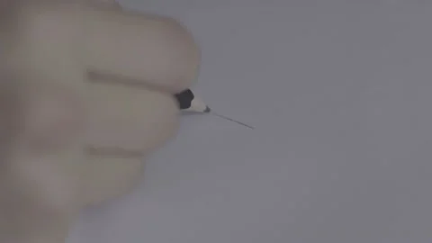 The guy is sitting at the table by the laptop. The guy writes, draws. Stock Footage 130219512