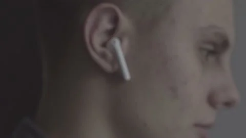 The guy is sitting at the table by the laptop. The guy writes, draws. Stock Footage 130219554