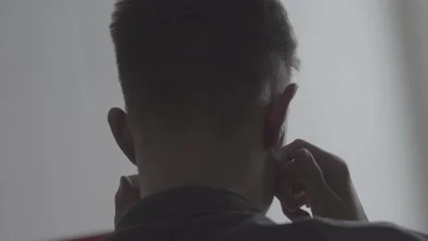 The guy is sitting at the table by the laptop. The guy writes, draws. Stock Footage 130219606