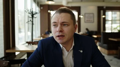 Guy is sitting at a table in a restaurant Stock Footage 81828963