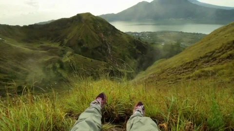 Guy is sitting on the top of the mountain. Video stock 82147662