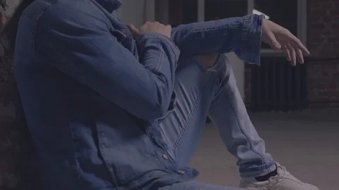 The guy is sitting by the wall Stock Footage 105566017