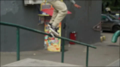 Guy on the skateboard slides on the railing and jumps off from them Stock Footage 94609076