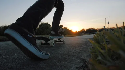 Guy Skateboarding on Sidewalk at Sunset Closeup - Slow Motion Stock Footage 87672960