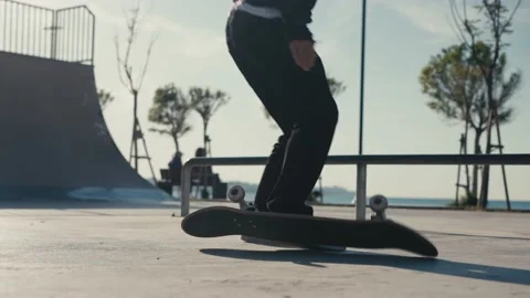 The guy skates on a ramp. Skateboarder Doing a Jump at a Concrete Skate Park. Stock Footage 194252012