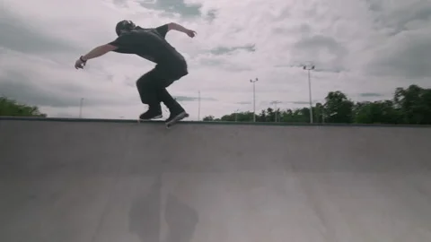 A guy skates on roller skates in a skate park Stock Footage 199838965