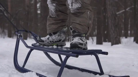 The guy is sledding while standing. Winter fun for children in quarantine. Stock Footage 149497532