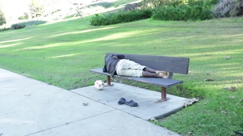 Guy Sleeping in the Park Bench Video stock 45434562