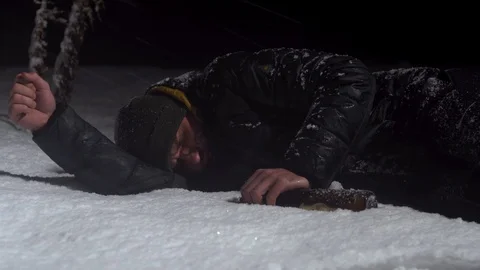 A guy sleeps in a pile of snow after going overboard with alcohol Stock Footage 122296017