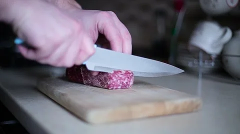Guy sliced sausage on the board close up Stock Footage 61455346