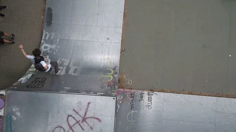 Guy slides down half pipe on shoes Stock Footage 107613313