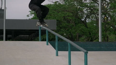 A guy slides on roller skates on a skatepark. Stock Footage 199839017