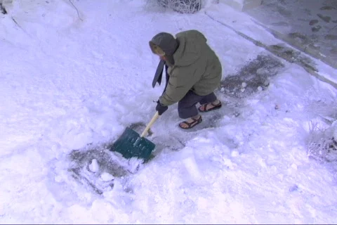 Guy slips shoveling snow Stock-Footage 453467
