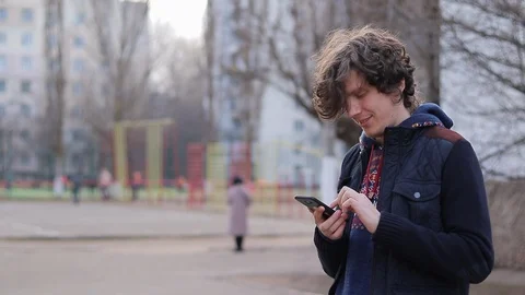 Guy with a smartphone on the playground Stock-Footage 125911197