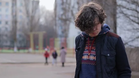 Guy with a smartphone on the playground Stock Footage 125911394