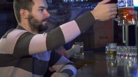Guy smells beer at the pub Video stock 73716959
