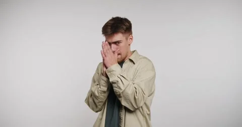 Guy smiles and claps with hands together while looking excited in a studio .. Vidéo 326788422