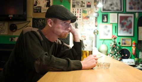 Guy smokes in the bar Stock Photos