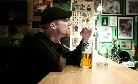 Guy smokes in the bar Stock Photos