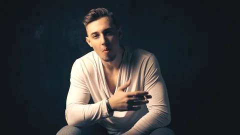 Guy smokes a cigarette Stock Footage 100134483