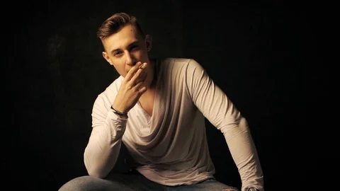 Guy smokes a cigarette Stock Footage 100134928