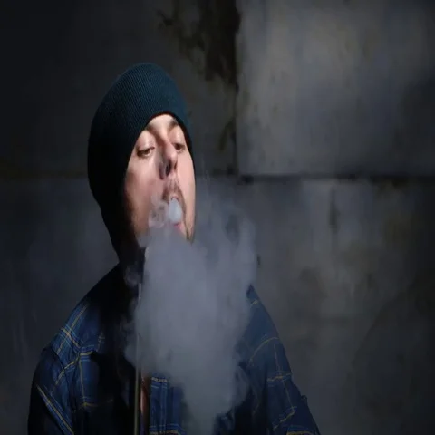 Guy smokes hookah and let smoke rings Stock Footage 69482920